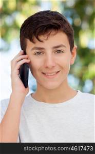 Teenage boy talking on the mobile in the street