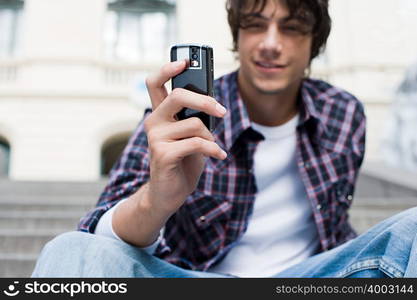 Teenage boy using a camera telephone