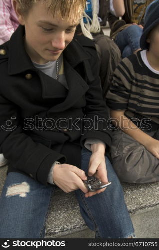 Teenage boy using a mobile phone