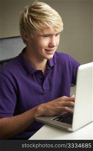 Teenage Boy Using Laptop At Home