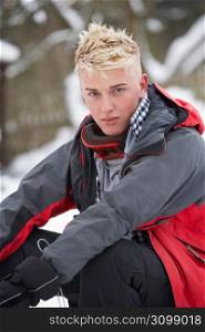 Teenage Boy Wearing Winter Clothes In Snowy Landscape