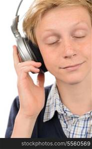 Teenage boy with eyes closed enjoying music over white background