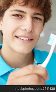 Teenage boy with toothbrush