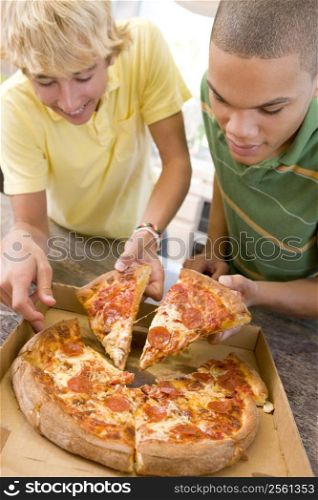 Teenage Boys Eating Pizza