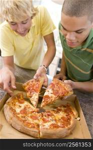 Teenage Boys Eating Pizza