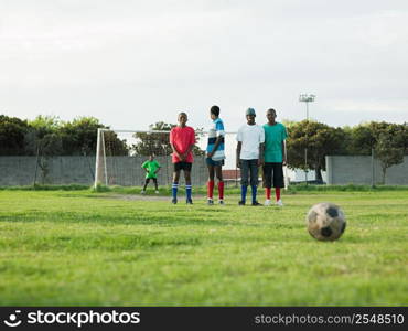 Teenage boys playing football