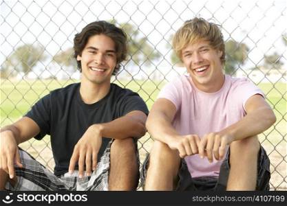Teenage Boys Sitting In Playground