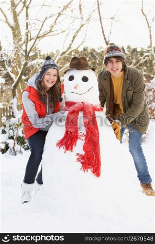 Teenage Couple Building Snowman