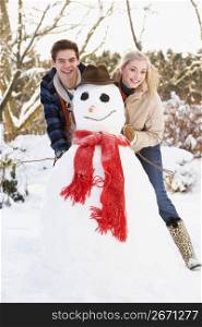 Teenage Couple Building Snowman