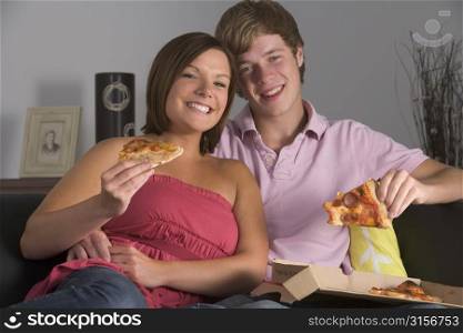 Teenage Couple Enjoying Pizza