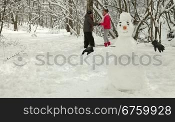 Teenage Couple Enjoying Winter Holidays in Snowy Forest