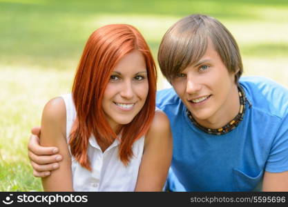 Teenage couple hugging enjoy summer day looking at camera