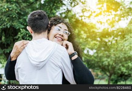 Teenage couple hugging outdoors, Close up of happy couple hugging in nature, Close up of smiling teenage couple hugging