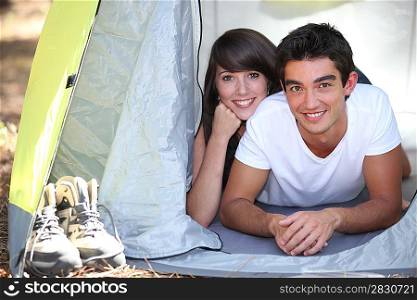 Teenage couple in a tent