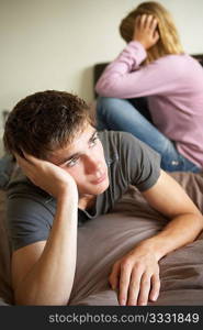 Teenage Couple In Bedroom After Argument