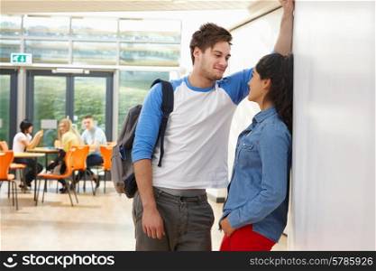 Teenage Couple Talking In School Classroom