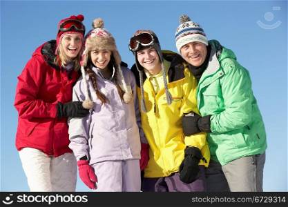 Teenage Family On Ski Holiday In Mountains