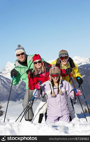 Teenage Family On Ski Holiday In Mountains