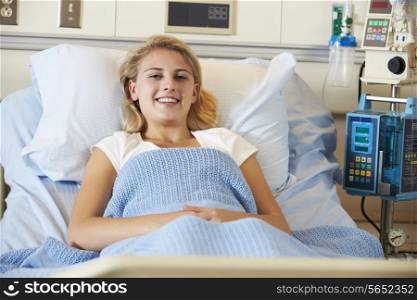 Teenage Female Patient Relaxing In Hospital Bed