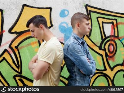 Teenage friends angry with wall graffiti background