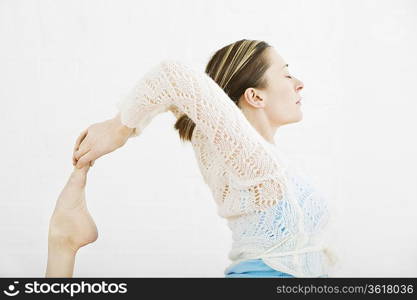 Teenage girl (16-17) performing yoga