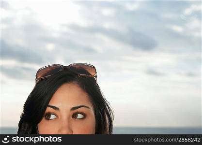 Teenage girl (16-17) wearing sunglasses on top of head close-up high section
