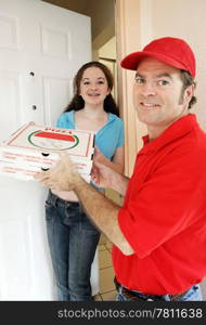 Teenage girl accepts pizza from delivery man. Vertical view.