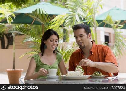 Teenage girl and a mid adult man sitting in a restaurant