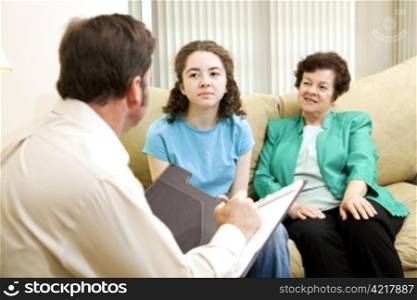 Teenage girl and her mother meeting with a psychologist. Could be some other type of interview.