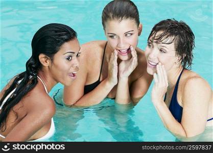 Teenage girl and two young women in a swimming pool