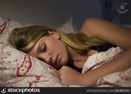 Teenage Girl Asleep In Bed At Night