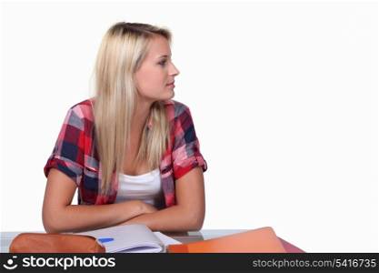 Teenage girl at desk revising