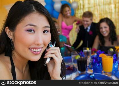 Teenage Girl at Party Using Cell Phone