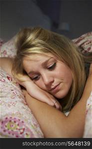 Teenage Girl Awake In Bed Suffering With Insomnia