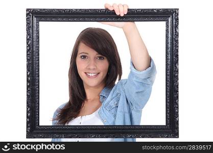 teenage girl behind a painting frame