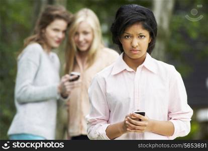Teenage Girl Being Bullied By Text Message On Mobile Phone
