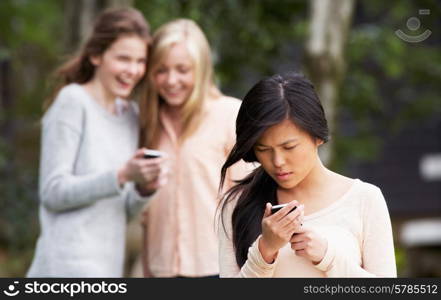 Teenage Girl Being Bullied By Text Message On Mobile Phone