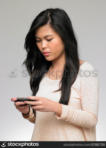 Teenage Girl Being Bullied By Text Message On Mobile Phone