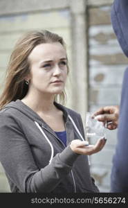 Teenage Girl Buying Drugs On The Street From Dealer