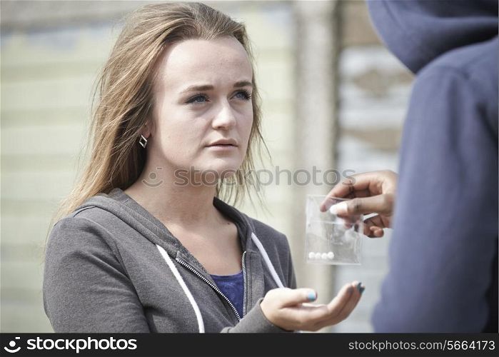 Teenage Girl Buying Drugs On The Street From Dealer