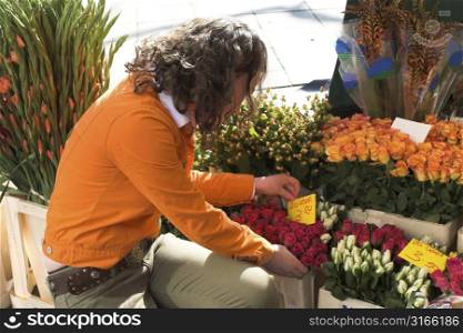 Teenage girl checking out the price of a bouquet of flowers