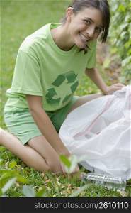 Teenage girl collecting garbage in a park