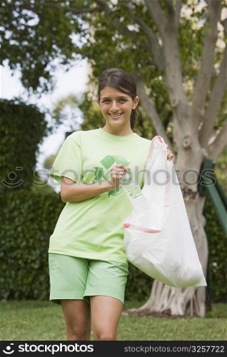 Teenage girl collecting garbage in a park
