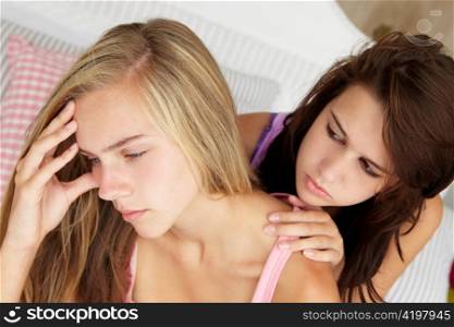 Teenage girl comforting friend