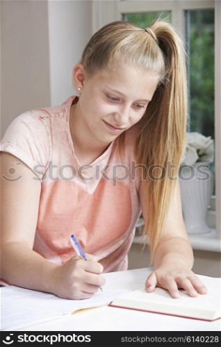 Teenage Girl Doing Homework At Table
