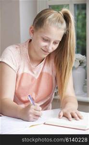 Teenage Girl Doing Homework At Table