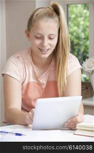Teenage Girl Doing Homework Using Digital Tablet