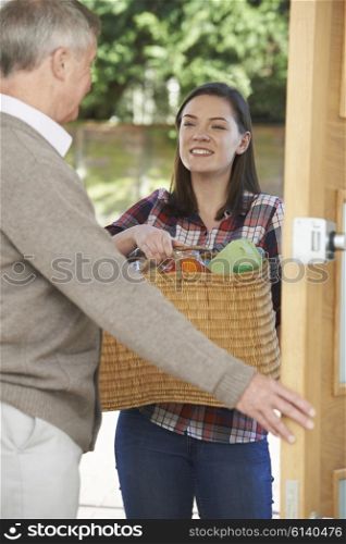 Teenage Girl Doing Shopping For Elderly Neighbour
