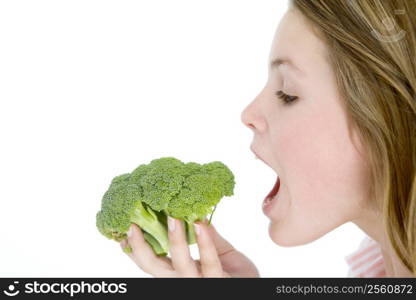 Teenage girl eating broccoli