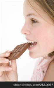 Teenage girl eating chocolate bar